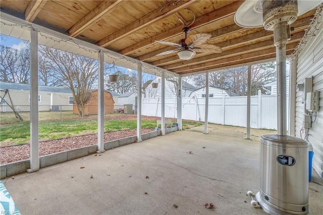 unfurnished sunroom featuring a ceiling fan