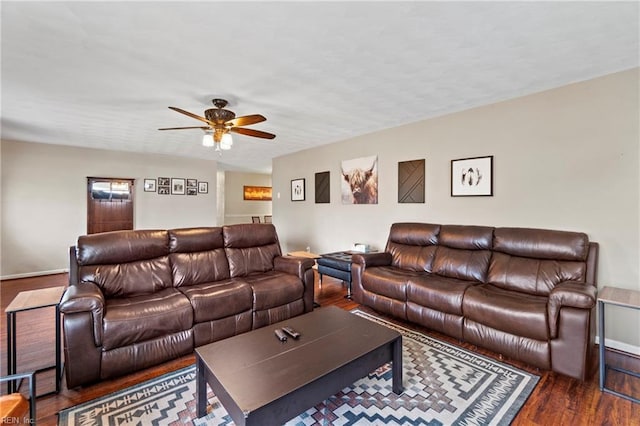 living room featuring a ceiling fan and wood finished floors