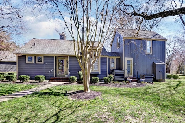 view of front of home featuring a front lawn, roof with shingles, and a chimney