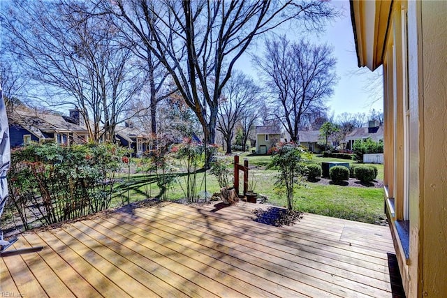 wooden deck with a yard and a residential view