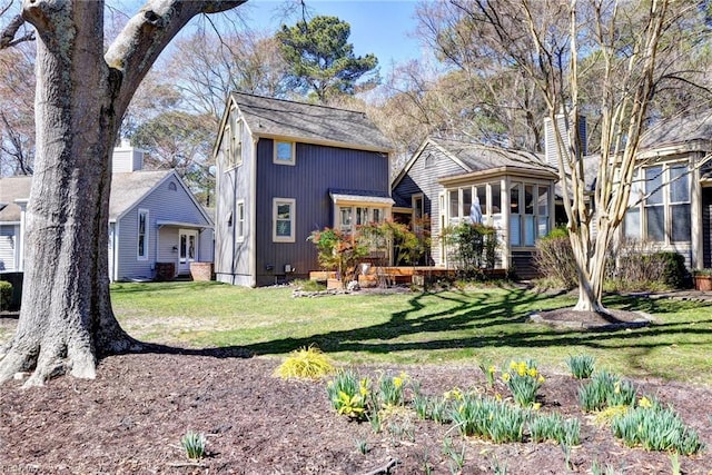 view of front facade featuring crawl space, a front yard, and a sunroom