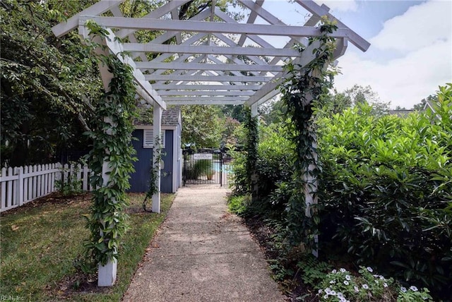 exterior space with a gate, fence, and a pergola