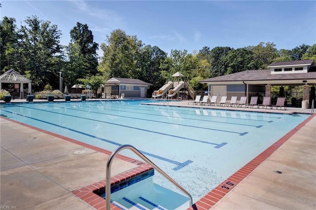 community pool featuring a gazebo, playground community, a patio, and fence