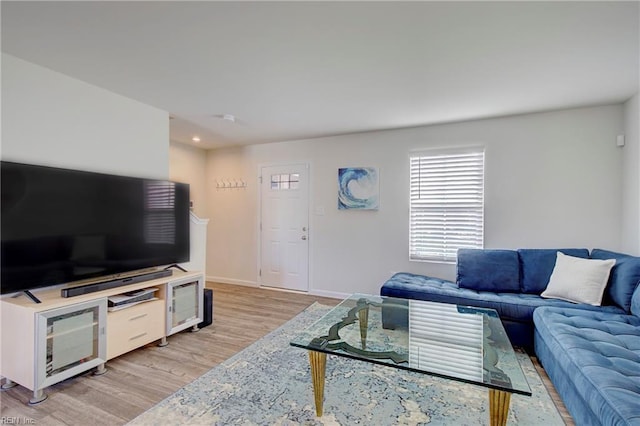 living room featuring light wood-style flooring and baseboards