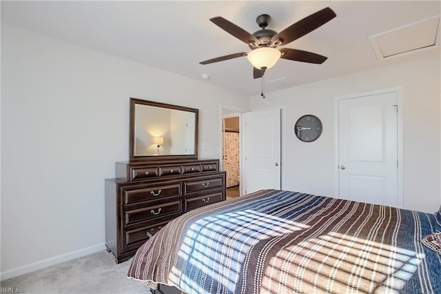 bedroom featuring light colored carpet, attic access, baseboards, and ceiling fan