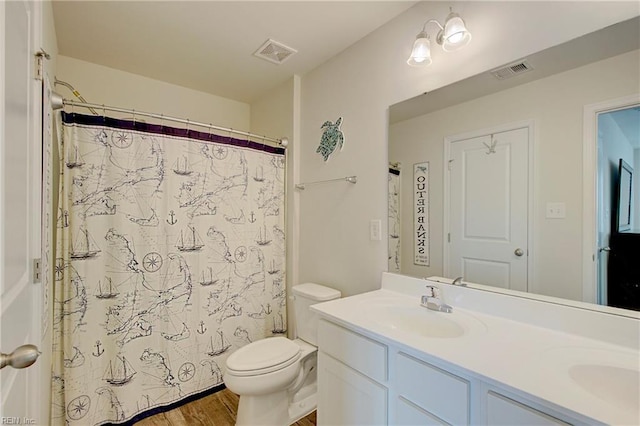 full bathroom with double vanity, visible vents, toilet, and a sink