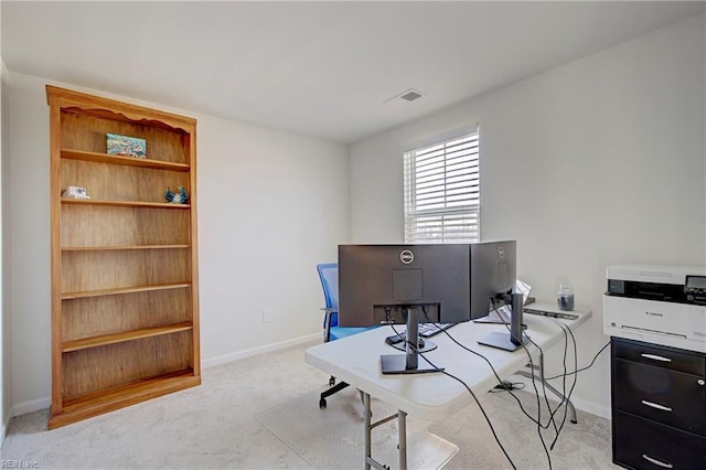 office with visible vents, light colored carpet, and baseboards