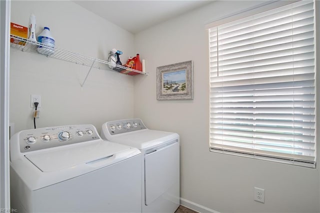 clothes washing area featuring washer and dryer and laundry area