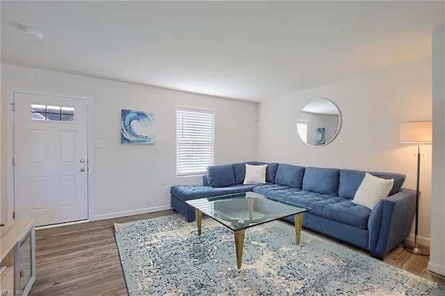 living room featuring wood finished floors and baseboards