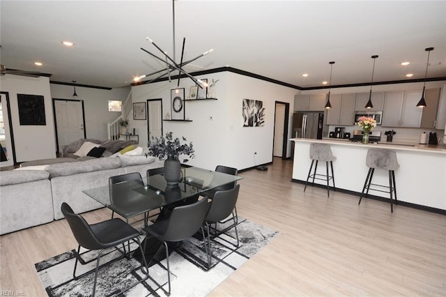 dining room with light wood-style flooring, recessed lighting, baseboards, and ornamental molding