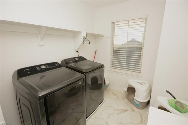 laundry area with baseboards, marble finish floor, laundry area, and washing machine and clothes dryer