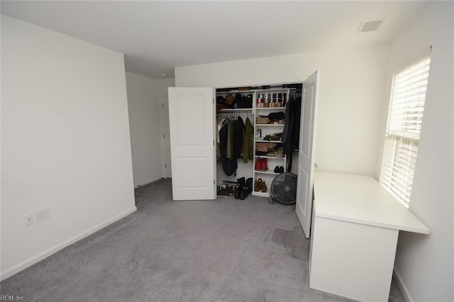 bedroom with a closet, baseboards, visible vents, and carpet flooring