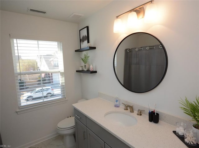 bathroom featuring visible vents, toilet, marble finish floor, baseboards, and vanity