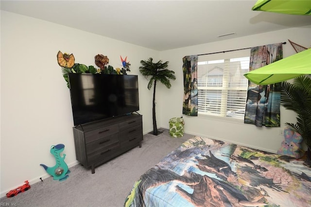 carpeted bedroom with visible vents and baseboards