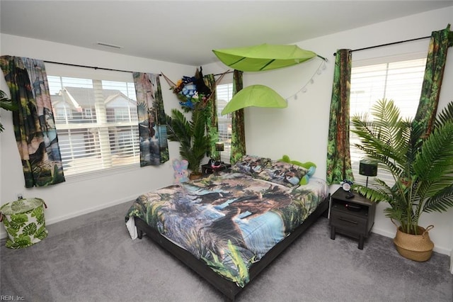 bedroom featuring visible vents, baseboards, and carpet