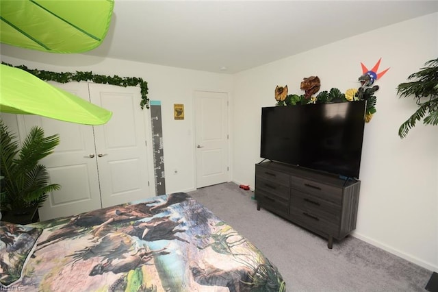 bedroom featuring a closet, carpet flooring, and baseboards