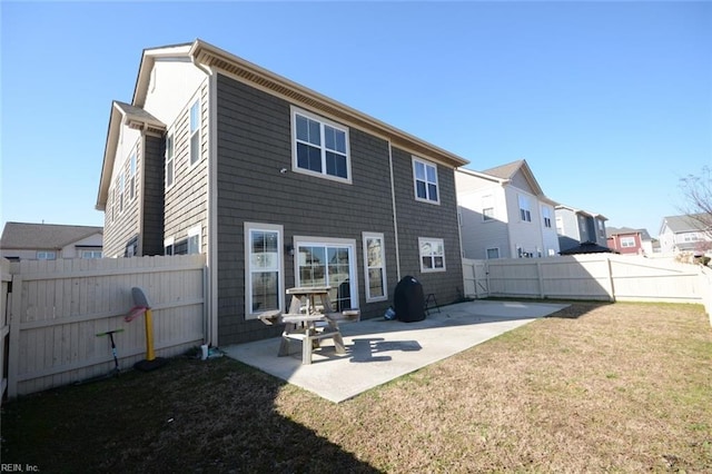 rear view of property with a patio area, a fenced backyard, and a yard