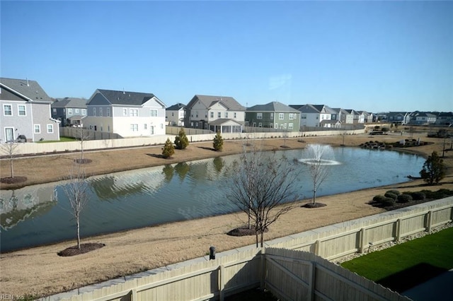 view of water feature with fence and a residential view