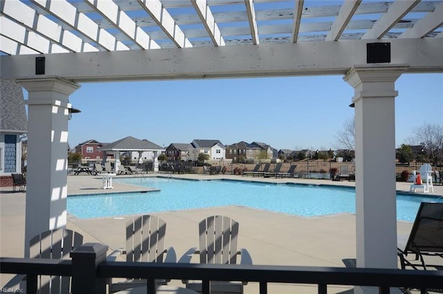 pool with a residential view, a patio, and a pergola