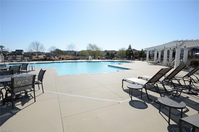 pool featuring a patio area and a pergola