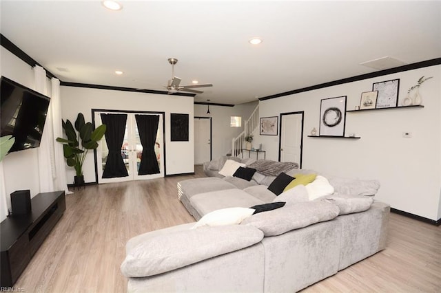 living room featuring crown molding, stairway, and recessed lighting