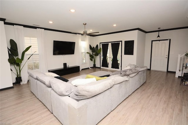 living area with crown molding, recessed lighting, light wood-style floors, plenty of natural light, and a ceiling fan