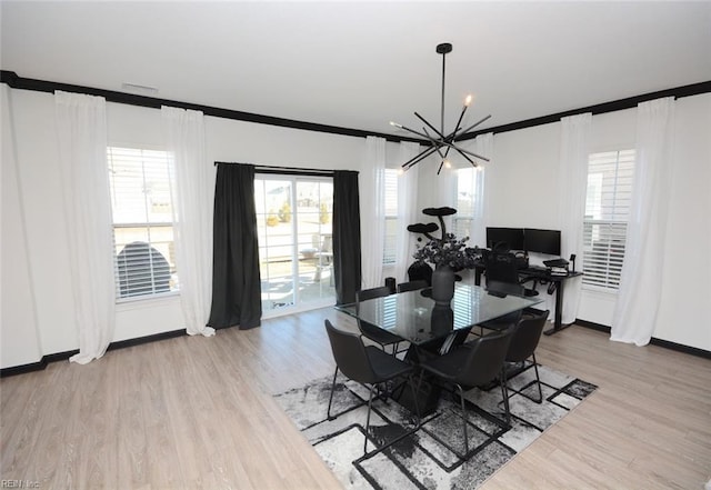 dining space with light wood-type flooring, visible vents, an inviting chandelier, crown molding, and baseboards