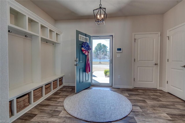 mudroom featuring wood finished floors, baseboards, and a chandelier