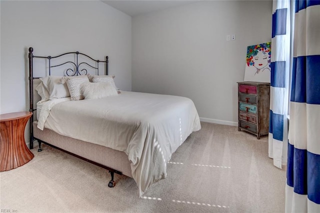 bedroom featuring carpet and baseboards