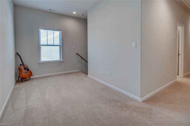 empty room with recessed lighting, visible vents, baseboards, and carpet flooring