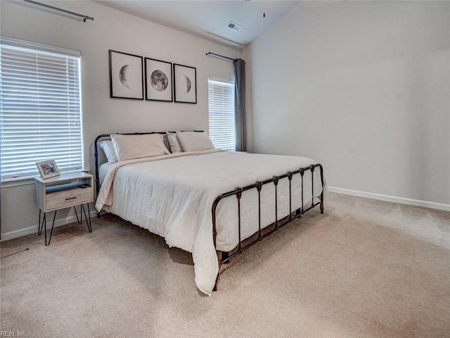 carpeted bedroom with visible vents, baseboards, a ceiling fan, and vaulted ceiling