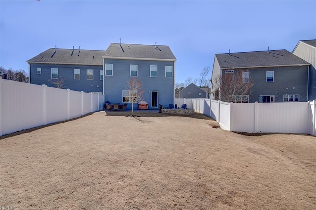 back of property with a patio and a fenced backyard