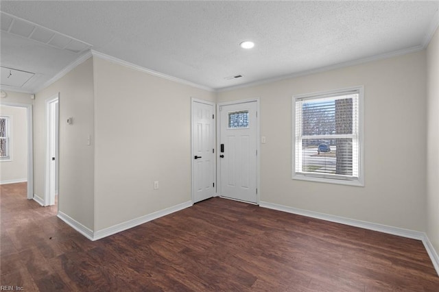 foyer featuring dark wood finished floors, baseboards, and ornamental molding