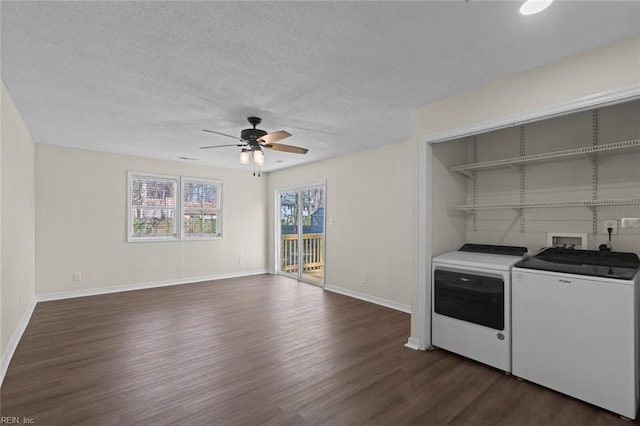 clothes washing area with a textured ceiling, dark wood-style floors, separate washer and dryer, ceiling fan, and laundry area