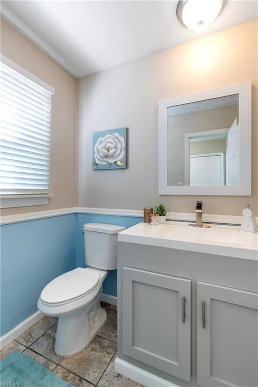 bathroom with tile patterned floors, toilet, vanity, and baseboards