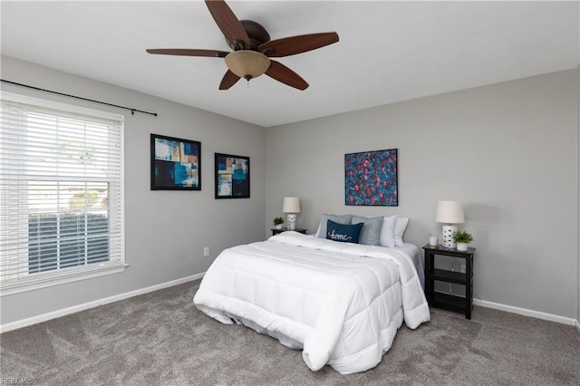 carpeted bedroom with a ceiling fan and baseboards