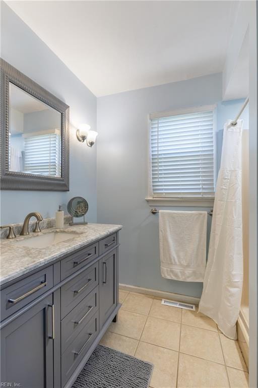 bathroom with vanity, tile patterned floors, curtained shower, and visible vents