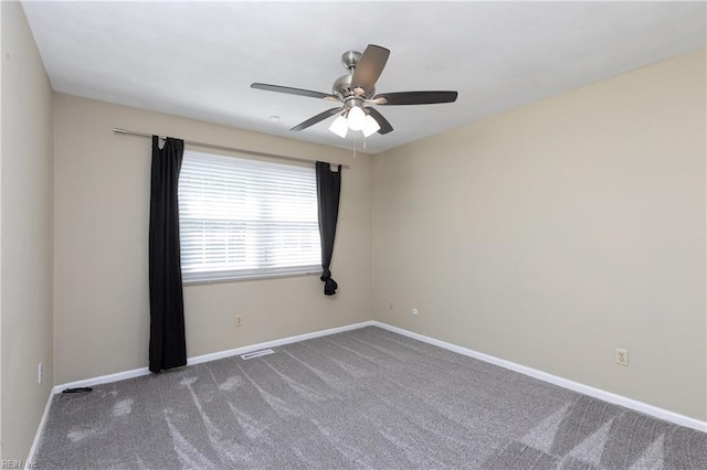 unfurnished room with carpet flooring, visible vents, baseboards, and ceiling fan