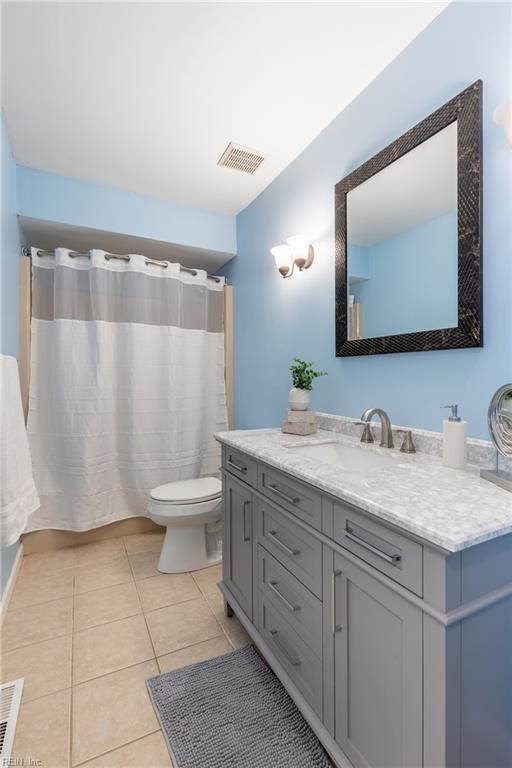 full bath with tile patterned flooring, toilet, vanity, and visible vents