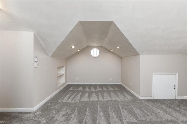 bonus room featuring carpet flooring, vaulted ceiling, built in features, and baseboards