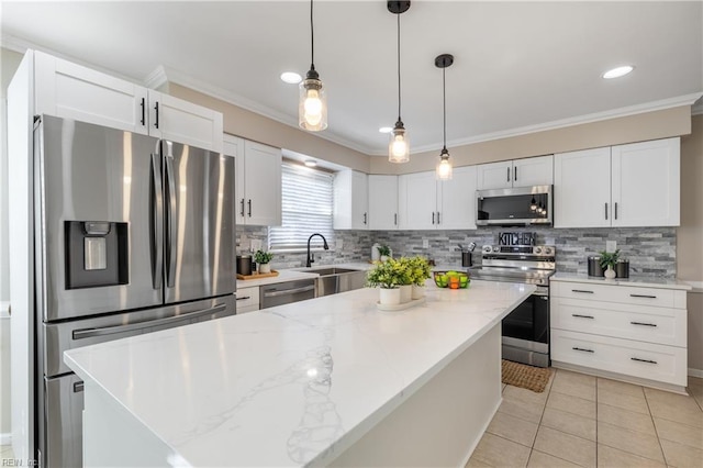 kitchen with ornamental molding, light tile patterned floors, appliances with stainless steel finishes, white cabinets, and a sink