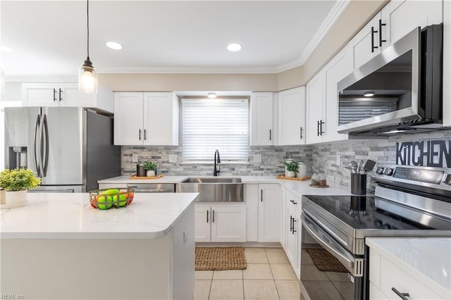 kitchen with crown molding, light tile patterned floors, light stone counters, stainless steel appliances, and a sink