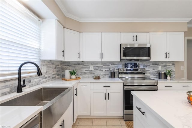 kitchen featuring a sink, stainless steel appliances, light stone countertops, and ornamental molding