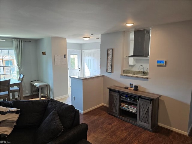 living area featuring baseboards and wood finished floors