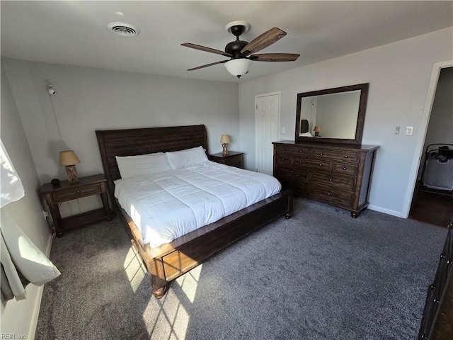 carpeted bedroom with a ceiling fan, baseboards, and visible vents