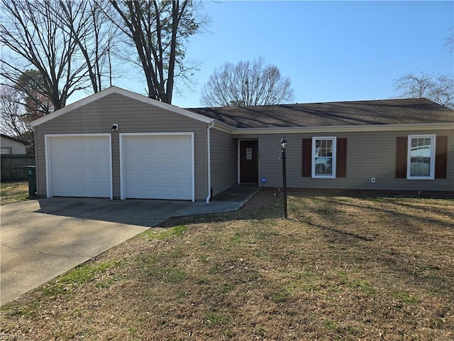 single story home featuring driveway, a front yard, and an attached garage