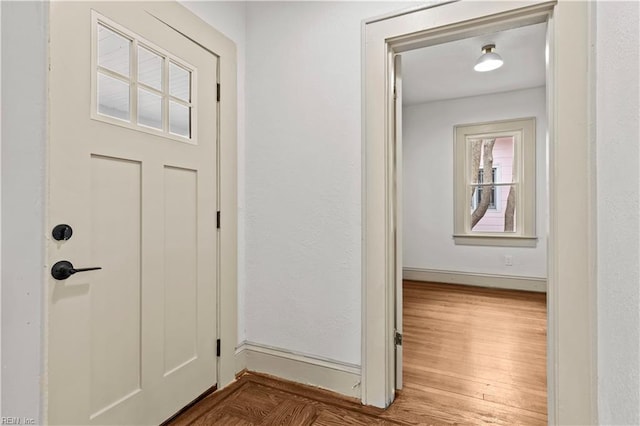 interior space featuring baseboards and wood finished floors