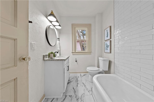 full bath featuring toilet, marble finish floor, baseboards, a bathtub, and vanity