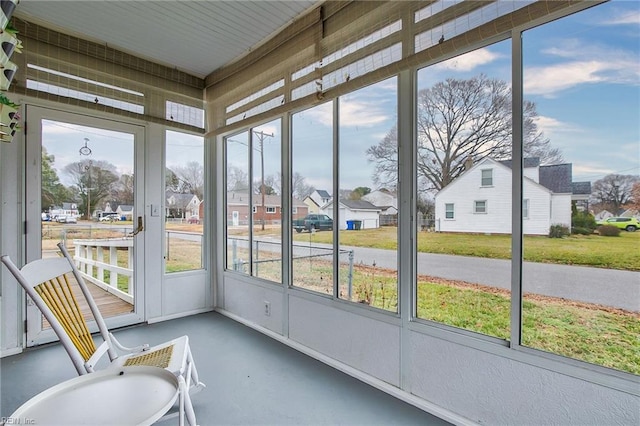 sunroom featuring a residential view