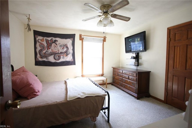 bedroom featuring light carpet, baseboards, and ceiling fan